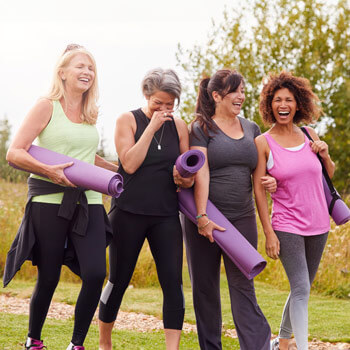 Diverse group of women walking to a yoga class outdoors